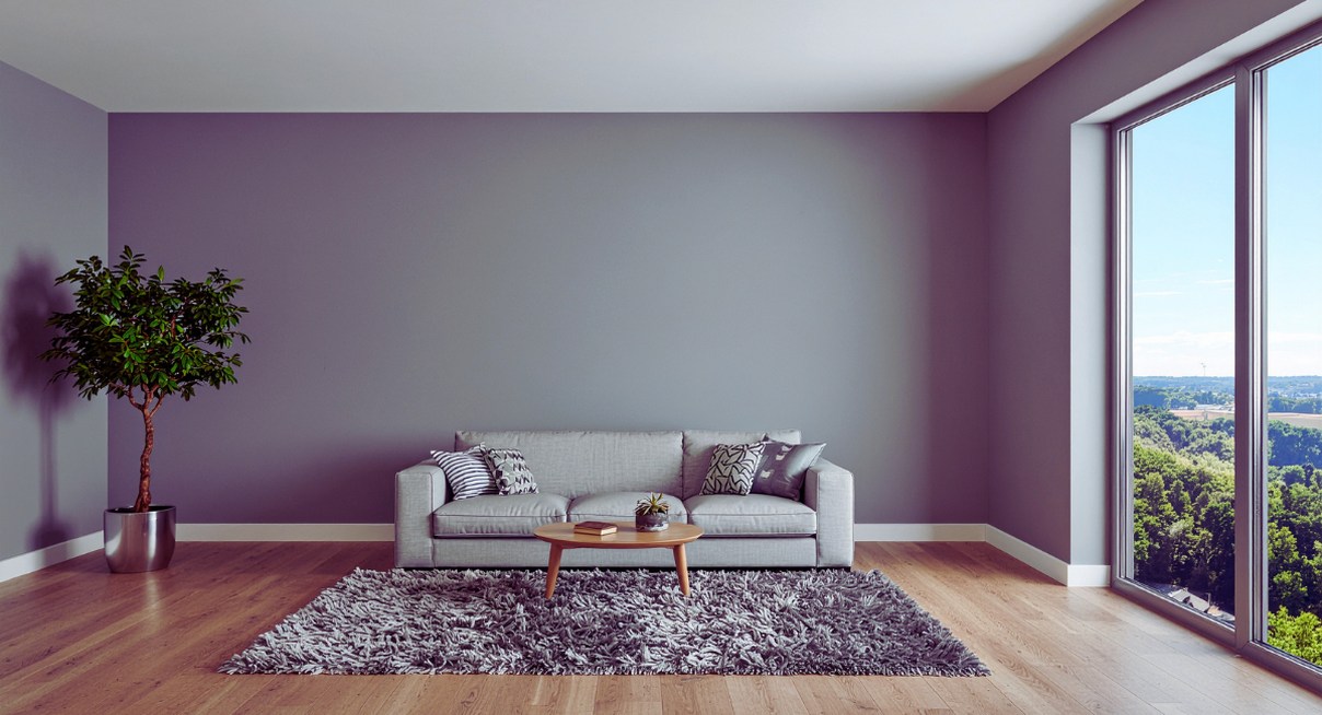 Salon épuré avec mur gris clair, canapé et grande fenêtre